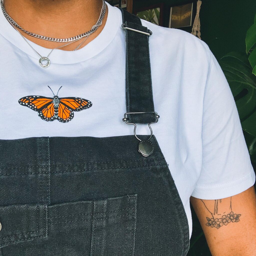 white tshirt with orange hand painted butterfly
