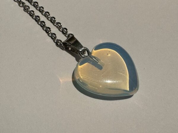 heart shaped clear opalite stone pendant on a silver chain